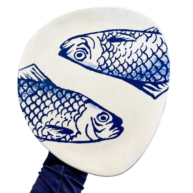 Hand-painted ceramic plate with blue fish design, created at Hot Spot Studios paint-your-own pottery studio