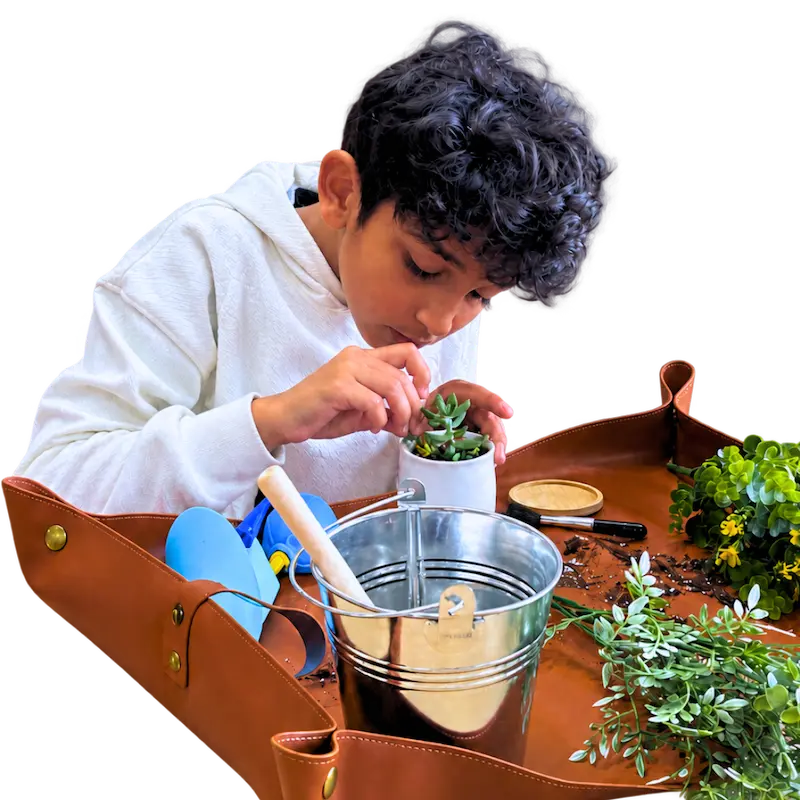 A guest makes a succulent garden at The Hot Spot Studios